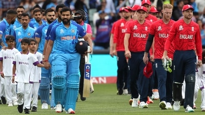 Rohit Sharma (L) and England captain Jos Buttler escort their respective teams ahead of the T20 World Cup semifinal (AFP)