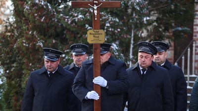 Russia-Ukraine War: Morticians stand outside a church during the funeral of one of two victims of a missile. (Reuters)