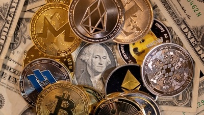 Representations of virtual cryptocurrencies are placed on U.S. dollar banknotes in this illustration. (REUTERS file)