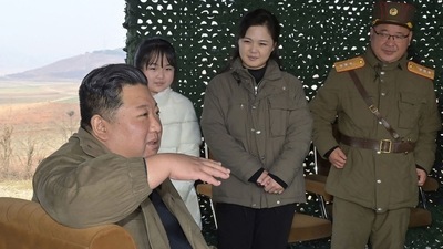 North Korea's leader Kim Jong Un (L), with his wife Ri Sol Ju (2nd R) and his daughter (2nd L-behind) attend the test-firing of the new intercontinental ballistic missile (ICBM). (AFP) North Korea's leader Kim Jong Un (L), with his wife Ri Sol Ju (2nd R) and his daughter (2nd L-behind) attend the test-firing of the new intercontinental ballistic missile (ICBM). (AFP)