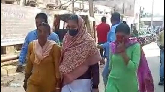 A video grab of the woman constable (centre) being taken to court. (HT Photo)