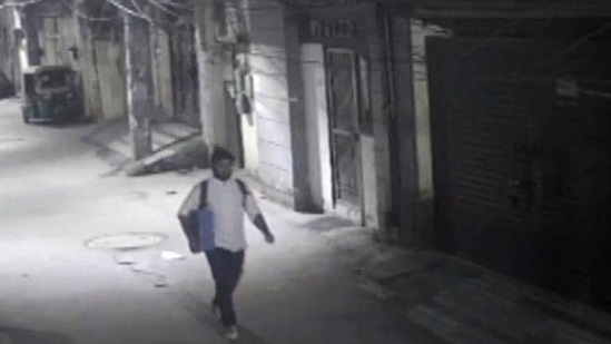 CCTV footage shows Aftab Poonawalla carrying a bag on a street outside his house in Delhi during the wee hours. (ANI)