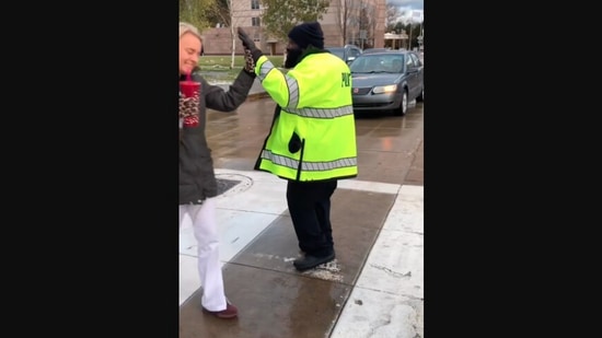 The image, taken from the Instagram video, shows the police officer whose unusual way of  greeting caregivers and visitors at a clinic went viral. (Instagram/@clevelandclinic)