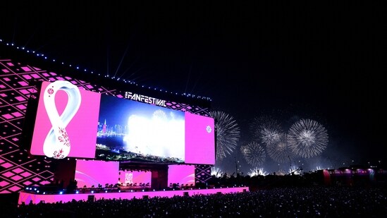 General view of fans at a stage during the opening of the FIFA fan festival as fireworks explode in the background.(REUTERS)