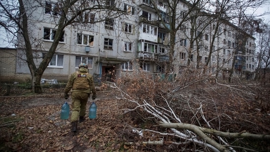 Russia-Ukraine War: A police officer distributes water to local residents, amid Russia's attack on Ukraine.(Reuters)