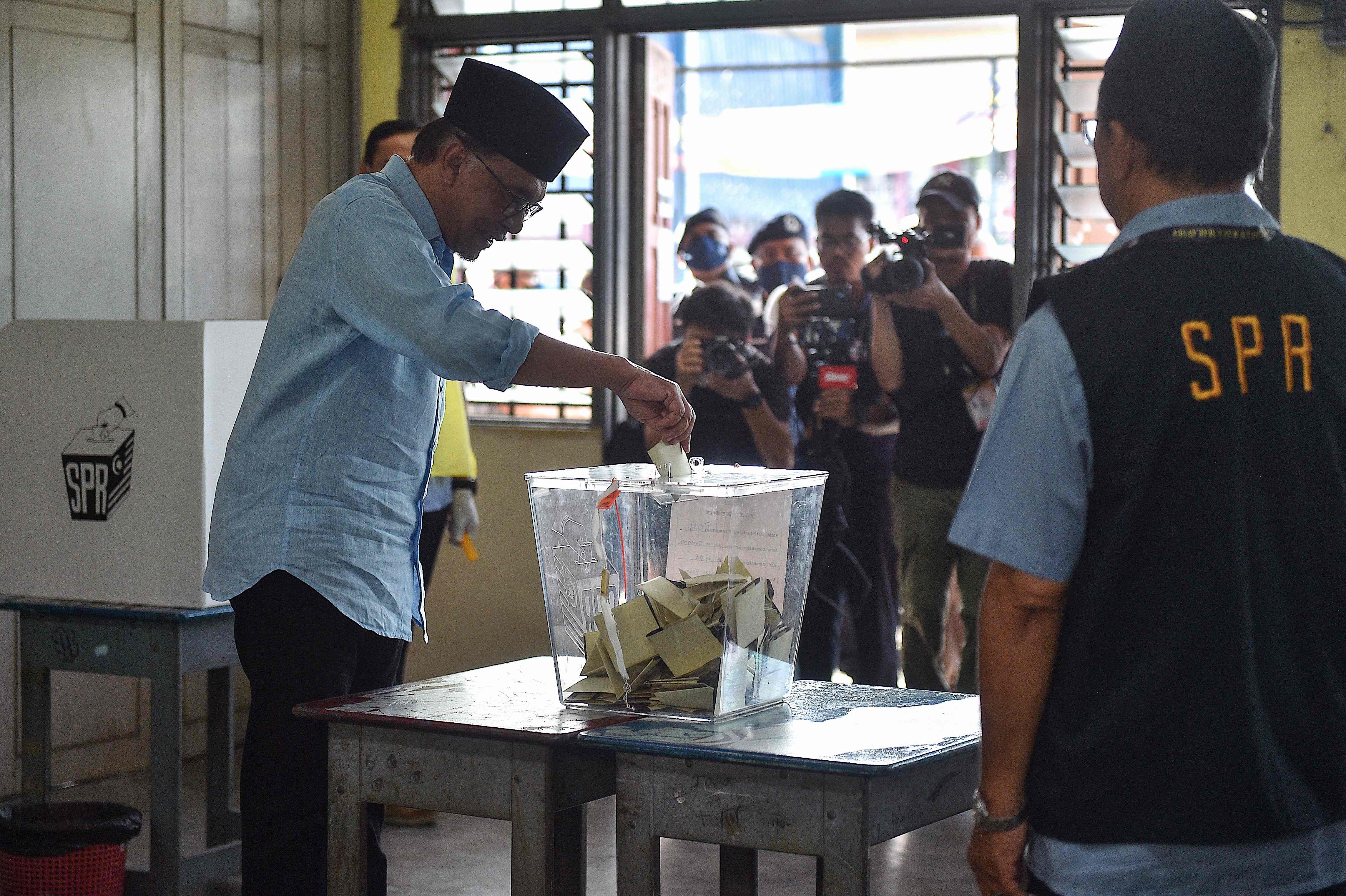 Malaysia Election: Malaysia's opposition leader Anwar Ibrahim, chairman of the Pakatan Harapan (Alliance of Hope), casts his ballot at a polling station during the general election in Permatang Pauh. (AFP) Malaysia Election: Malaysia's opposition leader Anwar Ibrahim, chairman of the Pakatan Harapan (Alliance of Hope), casts his ballot at a polling station during the general election in Permatang Pauh. (AFP)