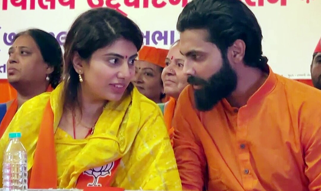 Indian cricketer Ravindra Jadeja interacts with his wife and Bharatiya Janata Party (BJP) candidate from Jamnagar (North) seat Rivaba Jadeja during an event ahead of her nomination filing for the Gujarat Assembly elections, in Jamnagar on Monday. (ANI Photo)