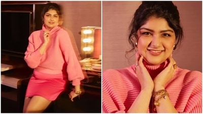 Anshula's light pink sweater features a high-rise turtle neckline, drop shoulders, ribbed knit details, drop shoulders, a baggy silhouette, full-length sleeves, cinched cuffs, and a cropped hem. Anshula wore the pullover with a hot pink-coloured mini skirt featuring a high-rise waist and a bodycon silhouette accentuating her curves. (Instagram) Anshula's light pink sweater features a high-rise turtle neckline, drop shoulders, ribbed knit details, drop shoulders, a baggy silhouette, full-length sleeves, cinched cuffs, and a cropped hem. Anshula wore the pullover with a hot pink-coloured mini skirt featuring a high-rise waist and a bodycon silhouette accentuating her curves. (Instagram)
