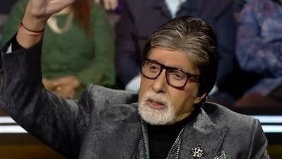 Amitabh Bachchan showing the height of stack of autographs he is supposed to sign after Kaun Banega Crorepati shoot.
