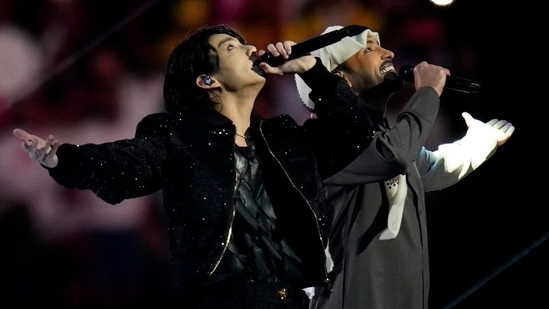 South Korean singer Jungkoo and Qatari singer Fahad Al Kubaisi perform during the opening ceremony of the 2022 FIFA World Cup at the Al Bayt Stadium in Al Khor , Qatar, Sunday. (AP Photo/Manu Fernandez)(AP)