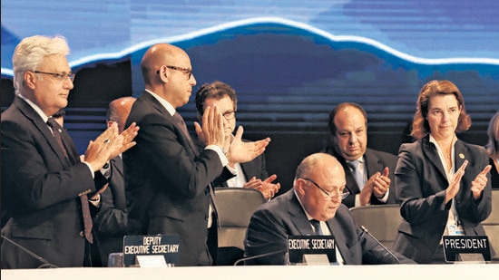 Delegates applaud after COP27 president Sameh Shoukry delivers a statement during the closing plenary at the COP27 climate summit in Egypt on Sunday (REUTERS)