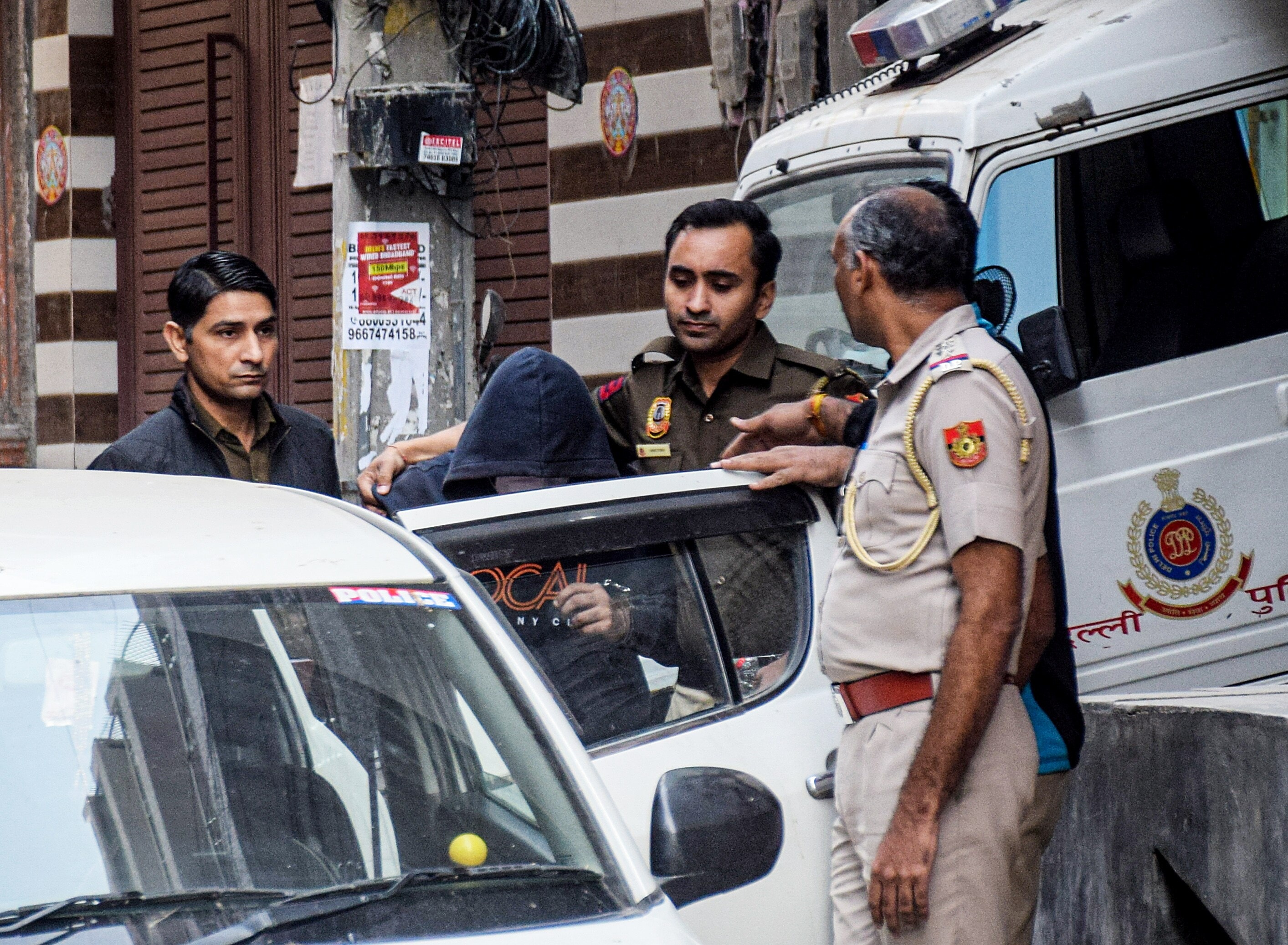 Accused Aaftab Amin Poonawalla (in hoodie) being taken by Delhi police personnel during an investigation in the Shraddha Walker murder case, in New Delhi on Sunday. (ANI Photo) Accused Aaftab Amin Poonawalla (in hoodie) being taken by Delhi police personnel during an investigation in the Shraddha Walker murder case, in New Delhi on Sunday. (ANI Photo)