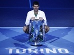 Novak Djokovic celebrates with the trophy after winning the men's singles final against Norway's Casper Ruud