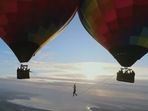 The image, taken from the Instagram video, shows the man walking between two hot air balloons.