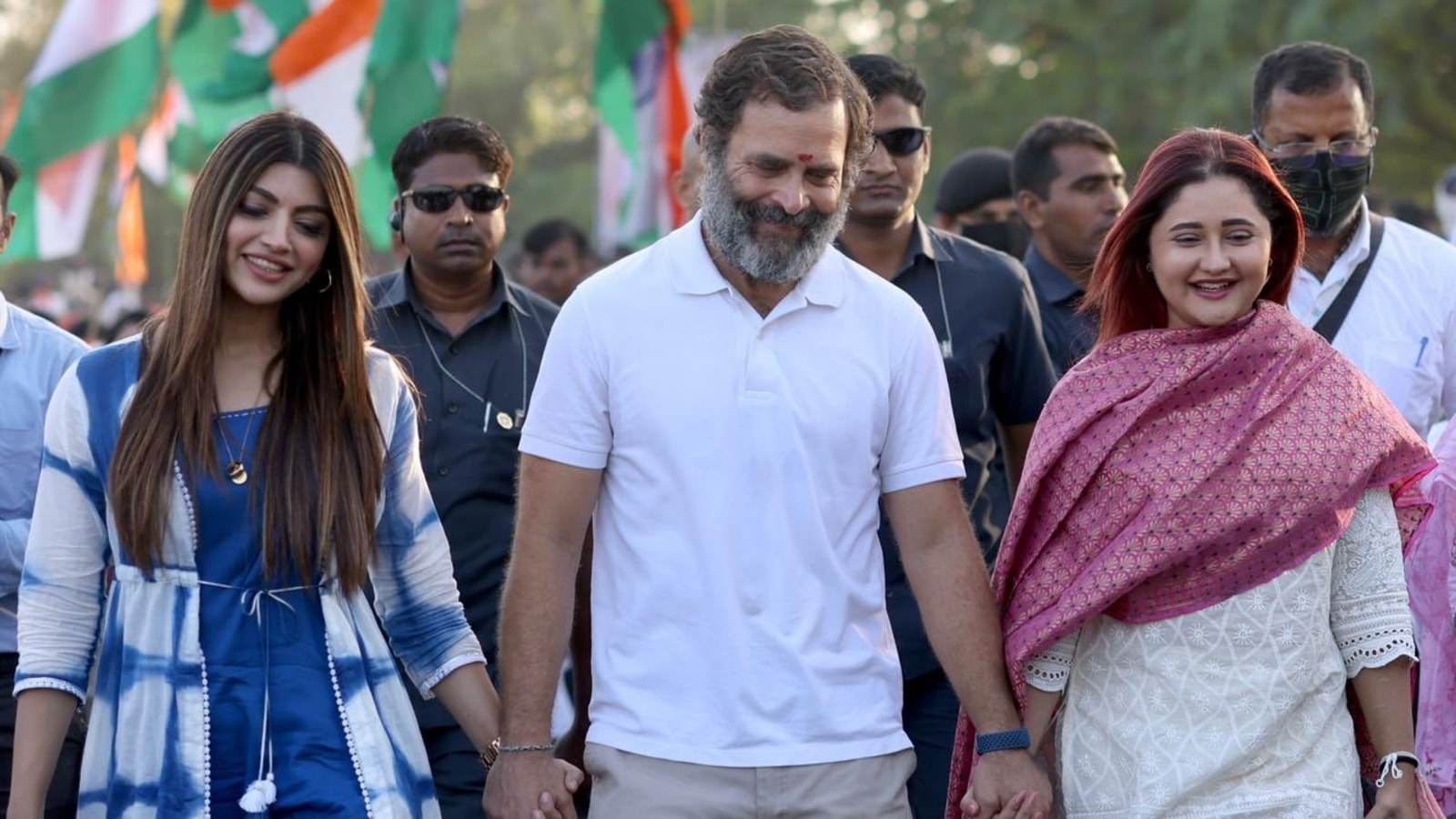 Rahul Gandhi holds Rashami Desai's hand as they walk together during