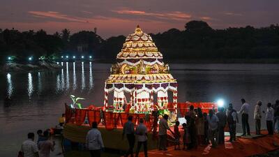 Bengaluru: A decorated boat (Teppotsava) with the idol of Dodda Basavanna (Bull) float on the historic Kempabudhi Lake as part of 'Kadalekai Parishe' (Groundnut Festival), in Bengaluru, Monday, Nov. 21, 2022. (PTI Photo/Shailendra Bhojak)(PTI11_21_2022_000236A) (PTI) Bengaluru: A decorated boat (Teppotsava) with the idol of Dodda Basavanna (Bull) float on the historic Kempabudhi Lake as part of 'Kadalekai Parishe' (Groundnut Festival), in Bengaluru, Monday, Nov. 21, 2022. (PTI Photo/Shailendra Bhojak)(PTI11_21_2022_000236A) (PTI)