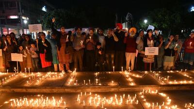 Teaching and non teaching staff at the candle protest at Sector 17 market plaza in Chandigarh. (Keshav Singh/HT)