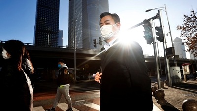 Covid In China: People walk across a street during morning rush hour, following the outbreak of the coronavirus disease. (Reuters)