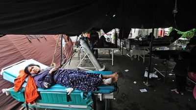 An earthquake survivor lies on a gurney at a makeshift hospital in Cianjur, West Java, Indonesia, Monday. (AP) An earthquake survivor lies on a gurney at a makeshift hospital in Cianjur, West Java, Indonesia, Monday. (AP)