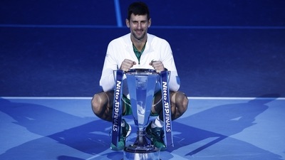 Novak Djokovic celebrates with the trophy after winning the men's singles final against Norway's Casper Ruud (REUTERS)