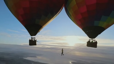 The image, taken from the Instagram video, shows the man walking between two hot air balloons. (YouTube/@Insta360)