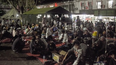 Wounded survivors of an earthquake are being treated in the yard of a hospital in Cianjur in Indonesia's Java. (AFP) Wounded survivors of an earthquake are being treated in the yard of a hospital in Cianjur in Indonesia's Java. (AFP)
