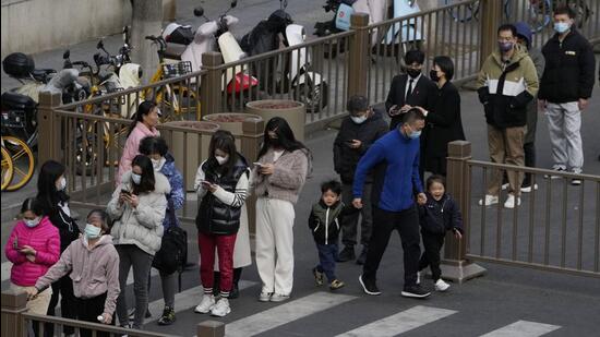 Residents line up for Covid tests in Beijing, on Monday. China is the only major country in the world still trying to curb virus transmissions through strict lockdown measures and mass testing. (AP)