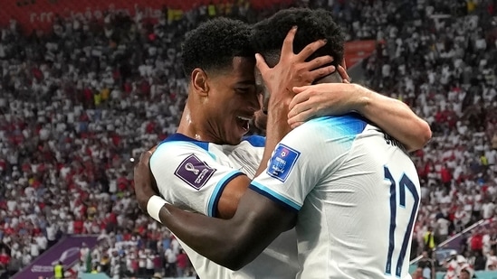 Bukayo Saka, right, and England's Jude Bellingham celebrate after scoring during the World Cup group B match between England and Iran at the Khalifa International Stadium(AP)