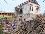 Indonesia Earthquake: Earthquake survivors collect usable items from the ruins of their house in Cianjur. Indonesia Earthquake: Earthquake survivors collect usable items from the ruins of their house in Cianjur.
