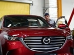Employees work on the production line of the CX-5 model car at the Mazda Sollers Manufacturing Rus joint venture plant of Sollers and Japanese Mazda.