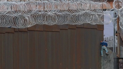 Mexico: A Haitian migrant climbs the Mexico border fence near the El Paso border. (AFP File) Mexico: A Haitian migrant climbs the Mexico border fence near the El Paso border. (AFP File)