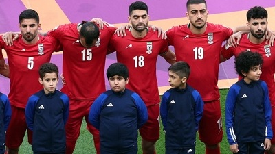 FIFA World Cup: Iran's Ali Karimi, Milad Mohammadi and Majid Hosseini line up during the national anthems before the match. (Reuters)