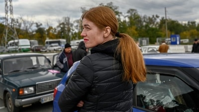 Russia-Ukraine War A Ukrainian woman looks on at a check point in Zaporizhzhia. (AFP)
