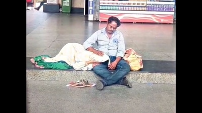 The man pats his wife as she rests her head in his lap. (Twitter/@Gulzar_sahab) The man pats his wife as she rests her head in his lap. (Twitter/@Gulzar_sahab)