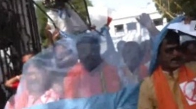 Kolkata: BJP leaders are seen wrapped in mosquito nets. (ANI)
