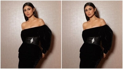 Mouni decked up in a black velvet off-shoulder dress featuring puffy full sleeves, and bodycon details below the waist. The dress also came with a diamond-shaped silver embellishment at the waist and added the necessary bling to her look. (Instagram/@imouniroy) Mouni decked up in a black velvet off-shoulder dress featuring puffy full sleeves, and bodycon details below the waist. The dress also came with a diamond-shaped silver embellishment at the waist and added the necessary bling to her look. (Instagram/@imouniroy)