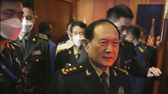 Chinese defence minister Gen Wei Fenghe (centre) walks out after a meeting with US secretary of defence Lloyd J Austin at the venue of the Asean defence ministers' meeting in Siem Reap, Cambodia, on Tuesday. (AP)