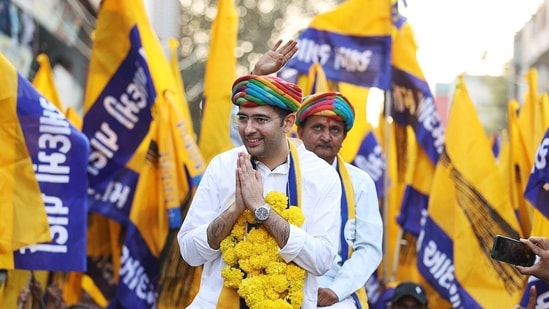 Aam Aadmi Party (AAP) MP Raghav Chadha greets the supporters during a roadshow for the upcoming Gujarat Assembly elections, at Dhrangdhra, in Surendranagar.(AAP Gujarat | Mission2022 Twitte)