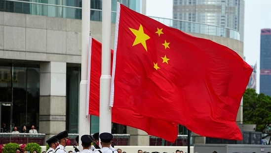 Hong Kong: Police officers raise Chinese and Hong Kong flags during a ceremony.(Reuters)