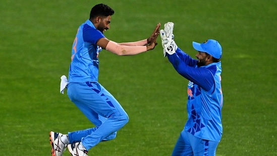 India's Mohammed Siraj (left) celebrates the wicket of New Zealand's Mitchell Santner(AP) India's Mohammed Siraj (left) celebrates the wicket of New Zealand's Mitchell Santner(AP)