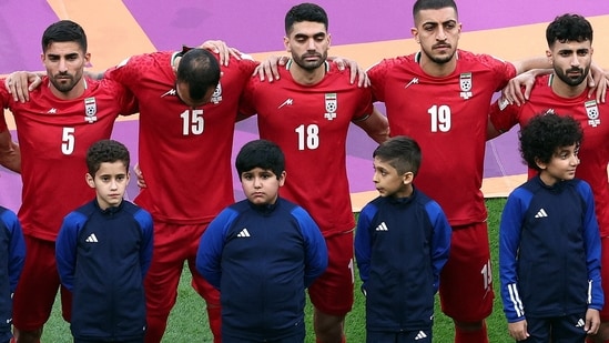 FIFA World Cup: Iran's Ali Karimi, Milad Mohammadi and Majid Hosseini line up during the national anthems before the match.(Reuters)