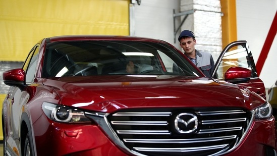 Employees work on the production line of the CX-5 model car at the Mazda Sollers Manufacturing Rus joint venture plant of Sollers and Japanese Mazda.(REUTERS)