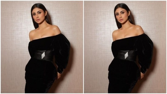 Mouni decked up in a black velvet off-shoulder dress featuring puffy full sleeves, and bodycon details below the waist. The dress also came with a diamond-shaped silver embellishment at the waist and added the necessary bling to her look.(Instagram/@imouniroy)