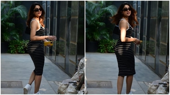 For the occasion, Sharvari picked a fitted sleeveless dress. It comes adorned in a black and white horizontal striped print and features broad straps, a plunging U neckline accentuating her décolletage, a figure-hugging silhouette highlighting her frame, and a midi-length hem.(HT Photo/Varinder Chawla)