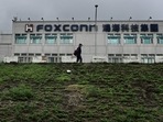 Foxconn China Violence: A man walking past the Foxconn headquarters.