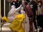 Covid In Shanghai: A medical worker in a protective suit collects a swab from a resident.