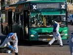 Israeli forensic experts gather at the scene of an explosion at a bus stop in Jerusalem on November 23, 2022. (AFP) Israeli forensic experts gather at the scene of an explosion at a bus stop in Jerusalem on November 23, 2022. (AFP)
