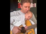 Man sings song for his newborn.