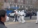 Security personnel in protective clothing seen taking away a person during protest at the factory compound operated by Foxconn Technology Group who runs the world's biggest Apple iPhone factory in Zhengzhou in China.(AP) Security personnel in protective clothing seen taking away a person during protest at the factory compound operated by Foxconn Technology Group who runs the world's biggest Apple iPhone factory in Zhengzhou in China.(AP)