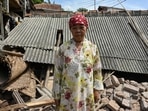 Resident Mimin poses by the rubble of her collapsed house in Cugenang, Cianjur on November 23, 2022, following a 5.6-magnitude earthquake that hit the area on November 21.